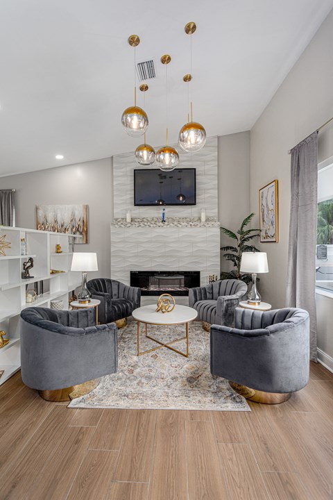 a living room with couches and a table and a fireplace